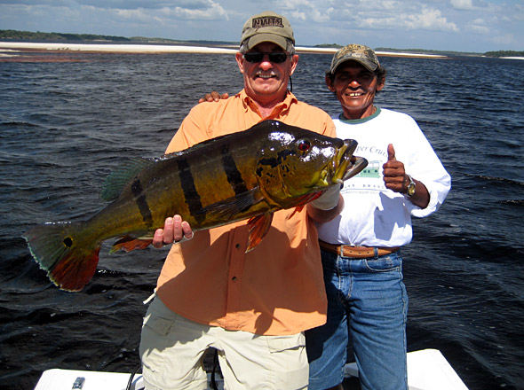 Dave Gizzi boats a monster 24 1/2 pound giant Speckled Peacock Bass from the legendary waters of the Rio Negro!