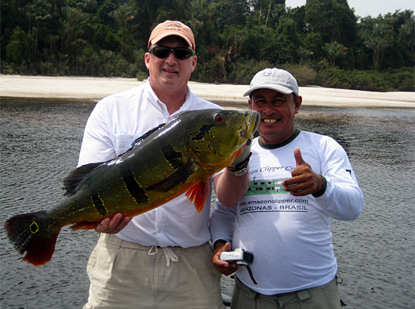 Adventurous angler Nick Owings with a giant peacock bass of about 24 pounds he caught on our last day of fishing with expert river guide G and Jim Taylor!